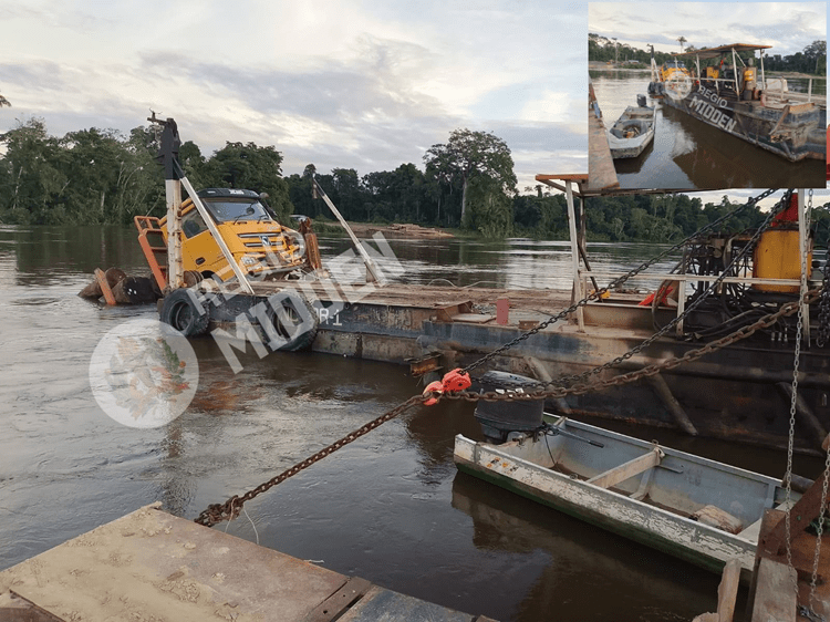 truck met houtblokken deels in de rivier